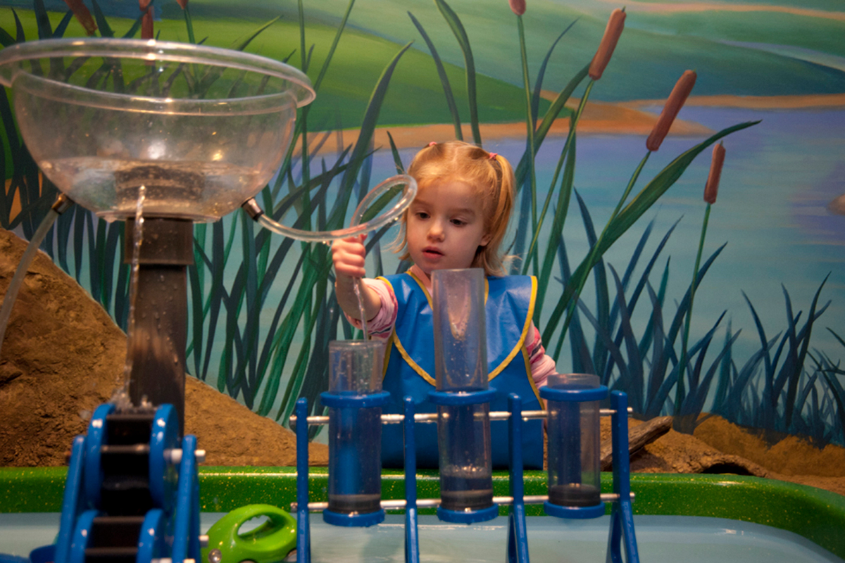 small girl playing with the toddler water table